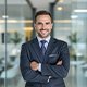 Happy Client Sharing Success Story with EuroLink Satisfied business owner discussing successful company setup in Dubai through EuroLink services.