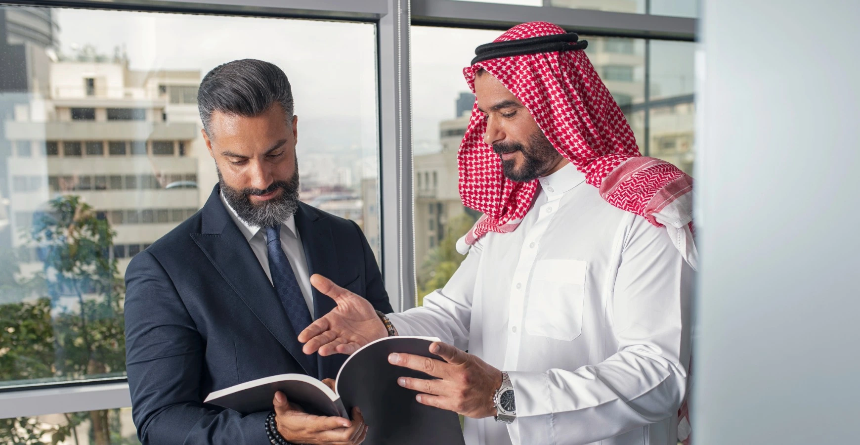 Dubai free zone company setup advisor discussing documents with Emirati client