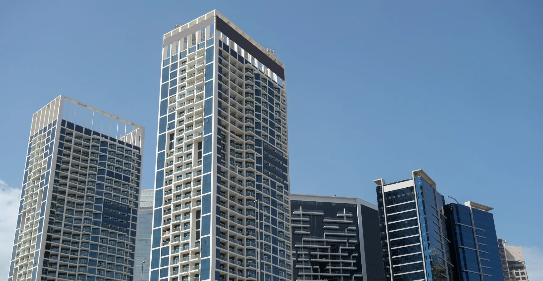 Sharjah Mainland Business Setup towers rising under clear blue sky