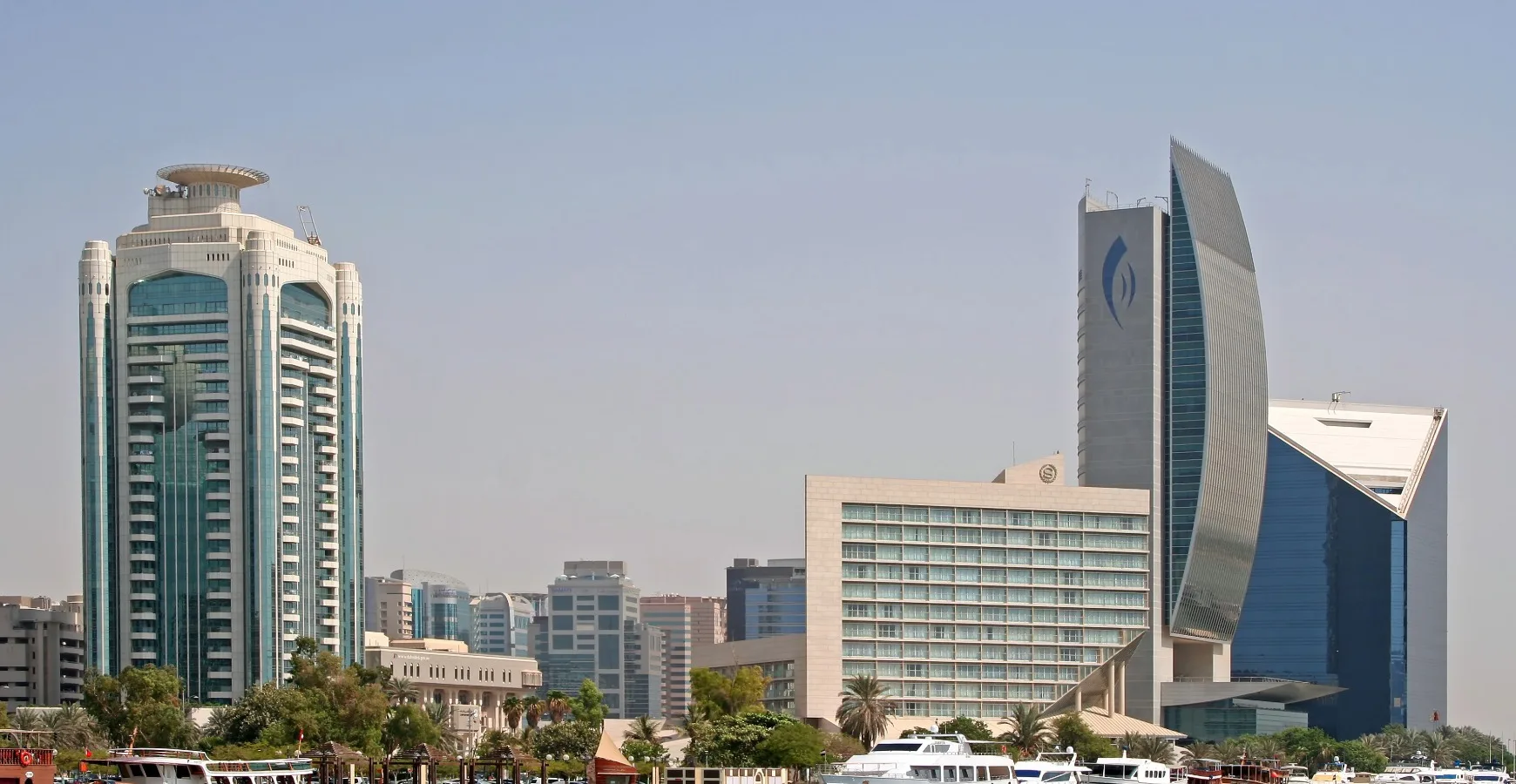 View of modern office skyscrapers along the Dubai Creek skyline, symbolizing commercial trade infrastructure and business setup through local Chamber Services.